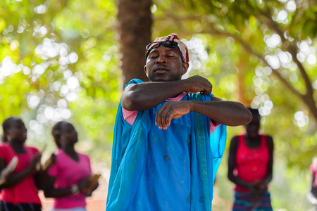 Kaguit vil., SENEGAL - APR 30, 2017: Unidentified Diola man in a dress moves during a traditional dance Kumpo in a Sacred Forest near Kaguit villageのeditorial素材