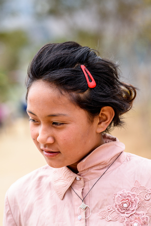 TRIMPHU, BHUTAN - MAR 8, 2017: Unidentified Ngalops beautiful little giirl looks ahead. Ngalops is one of the most populous ethnic groups of Bhutanのeditorial素材