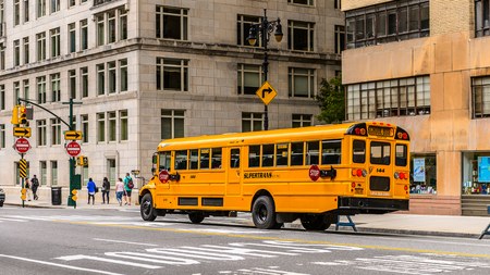 NEW YORK, USA - SEP 22, 2015: Yellow school bus on the Eighth avenue (Manhattan). 8 avenue begins in the West Village neighborhood at Abingdon Squareのeditorial素材