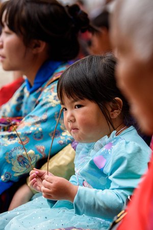TRIMPHU, BHUTAN - MAR 8, 2017: Unidentified Ngalops little girl sits in the crowd. Ngalops is one of the most populous ethnic groups of Bhutanのeditorial素材