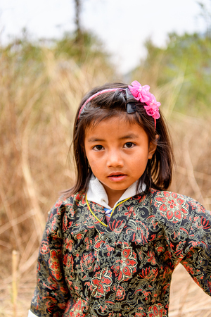 TRIMPHU, BHUTAN - MAR 8, 2017: Unidentified Ngalops beautiful little girl looks ahead. Ngalops is one of the most populous ethnic groups of Bhutanのeditorial素材