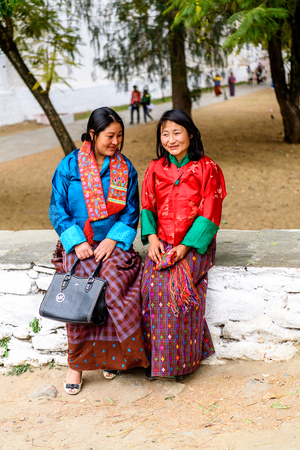 TRIMPHU, BHUTAN - MAR 8, 2017: Unidentified Ngalops women in traditional clothes stand on the street. Ngalops is one of the most populous ethnic groups of Bhutanのeditorial素材