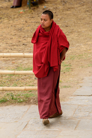 TRIMPHU, BHUTAN - MAR 8, 2017: Unidentified Ngalops man in traditional clothes in a temple. Ngalops is one of the most populous ethnic groups of Bhutanのeditorial素材