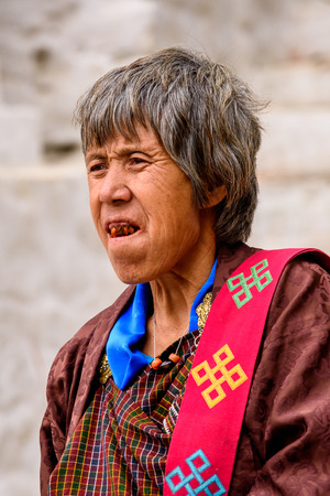 TRIMPHU, BHUTAN - MAR 8, 2017: Unidentified Ngalops old man in traditional clothes stands on the street. Ngalops is one of the most populous ethnic groups of Bhutanのeditorial素材