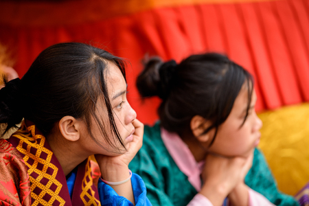 TRIMPHU, BHUTAN - MAR 8, 2017: Unidentified Ngalops two women watch the perfomance. Ngalops is one of the most populous ethnic groups of Bhutanのeditorial素材