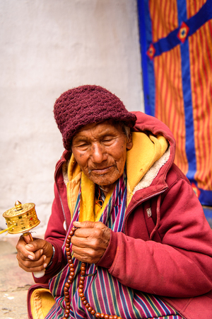 TRIMPHU, BHUTAN - MAR 8, 2017: Unidentified Ngalops old man in traditional clothes and a hat. Ngalops is one of the most populous ethnic groups of Bhutanのeditorial素材