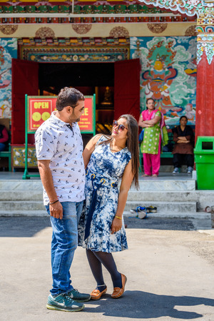 SIKKIM, INDIA - MAR 13, 2017: Unidentified Indian man and woman look at each other in the middle of the street.のeditorial素材