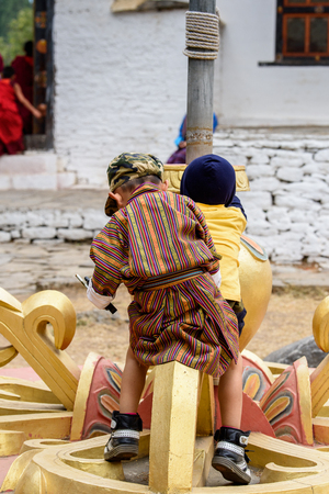 TRIMPHU, BHUTAN - MAR 8, 2017: Unidentified Ngalops little boy plays on the street. Ngalops is one of the most populous ethnic groups of Bhutanのeditorial素材