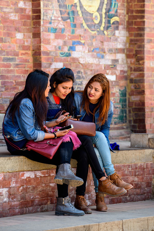 KATMANDU, NEPAL - MAR 6, 2017: Unidentified Chhetri three girls talk about something. Chhetris is the most populous ethnic group of Nepalのeditorial素材