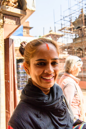 KATMANDU, NEPAL - MAR 6, 2017: Unidentified Chhetri woman in black headscarf and red dot on her forehead smiles. Chhetris is the most populous ethnic group of Nepalのeditorial素材