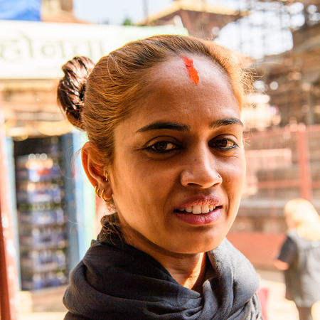 KATMANDU, NEPAL - MAR 6, 2017: Unidentified Chhetri woman in black headscarf and red dot on her forehead smiles. Chhetris is the most populous ethnic group of Nepalのeditorial素材