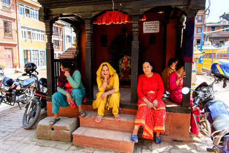 KATMANDU, NEPAL - MAR 6, 2017: Unidentified Chhetri women in traditional clothes sit near the altar. Chhetris is the most populous ethnic group of Nepalのeditorial素材