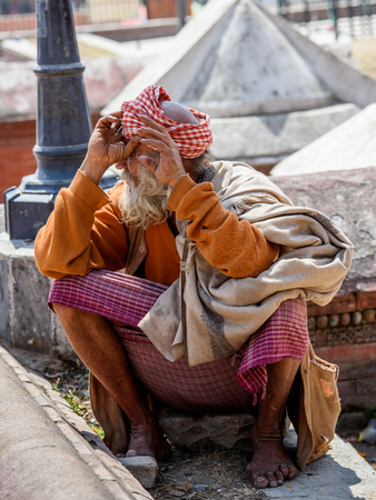 KATMANDU, NEPAL - MAR 6, 2017: Unidentified Chhetri man with beard in traditional clothes looks around. Chhetris is the most populous ethnic group of Nepalのeditorial素材