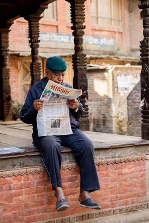 KATMANDU, NEPAL - MAR 6, 2017: Unidentified Chhetri man reads a paper. Chhetris is the most populous ethnic group of Nepalのeditorial素材
