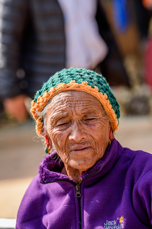 KATMANDU, NEPAL - MAR 6, 2017: Unidentified Chhetri old woman in violet jacket looks ahead. Chhetris is the most populous ethnic group of Nepalのeditorial素材