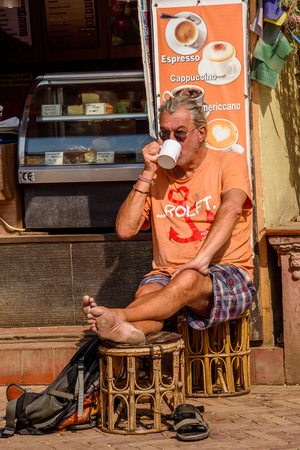 KATMANDU, NEPAL - MAR 6, 2017: Unidentified European tourist drinks a cup of coffe.のeditorial素材