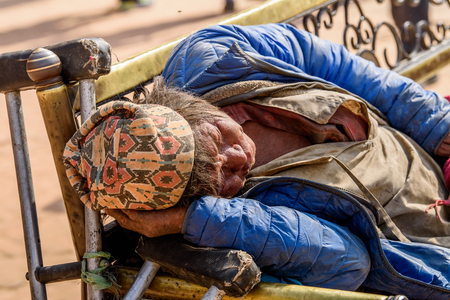 KATMANDU, NEPAL - MAR 6, 2017: Unidentified Chhetri old woman sleeps on the bench. Chhetris is the most populous ethnic group of Nepalのeditorial素材