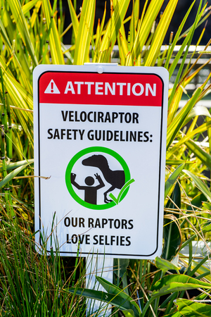 LOS ANGELES, USA - SEP 27, 2015: Attention sign in Jurassic Park area in the Universal Studios Hollywood Park. Jurassic Park is a 1993 American adventure film  by Steven Spielbergのeditorial素材