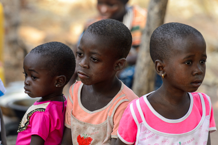 KOUTAMMAKOU, TOGO - JAN 13, 2017: Unidentified Togolese  little girl looks somewhere in the village. Togo children suffer of poverty due to the bad economy.のeditorial素材