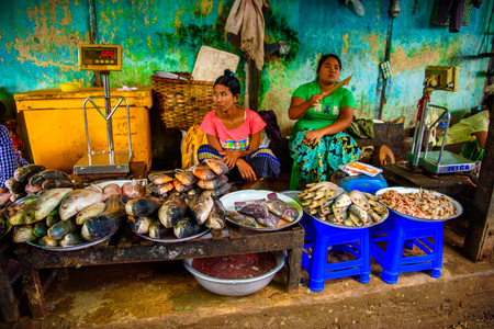 BAGAN, MYANMAR - AUG 27, 2016: Unidentified Burmese women work at the local market. 68 per cent of Myanma people belong to Bamar ethnic groupのeditorial素材