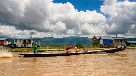 INLE LAKE, MYANMAR - AUG 30, 2016: Unidentified Burmese people in bamboo boat sails over the Inle Sap,  a freshwater lake located in the Nyaungshwe Township of Taunggyi District of Shan State, Myanmarのeditorial素材