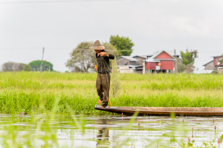 INLE LAKE, MYANMAR - AUG 30, 2016: Unidentified Burmese man in bamboo boat sails over the Inle Sap,a freshwater lake located in the Nyaungshwe Township of Taunggyi District of Shan State, Myanmarのeditorial素材