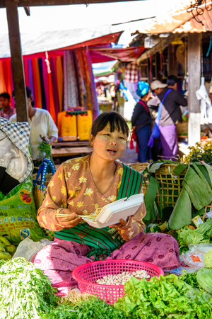 INLE LAKE, MYANMAR - AUG 30, 2016: Unidentified Burmese woman works at the market place, the Inle Sap,a freshwater lake  in the Nyaungshwe Township of Taunggyi District of Shan State, Myanmarのeditorial素材