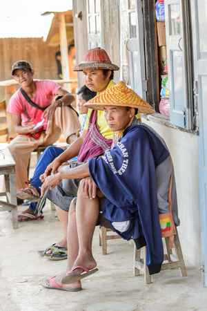 INLE LAKE, MYANMAR - AUG 30, 2016: Unidentified Burmese man in traditional hat on a wooden boat. 68 per cent of Myanma people belong to Bamar ethnic groupのeditorial素材