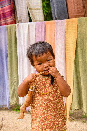 INLE LAKE, MYANMAR - AUG 30, 2016: Unidentified Burmese little girl in the street. 68 per cent of Myanma people belong to Bamar ethnic groupのeditorial素材