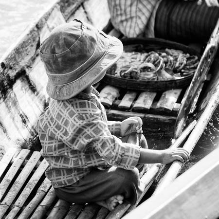 INLE LAKE, MYANMAR - AUG 30, 2016: Unidentified Burmese little boy in a wooden boat. 68 per cent of Myanma people belong to Bamar ethnic groupのeditorial素材