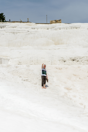 PAMUKKALE, TURKEY - APR 18, 2015: Unidentified tourists walk on the travertines of Pamukkale, Turkey. It's a UNESCO World Heritage siteのeditorial素材