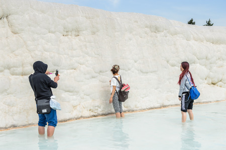 PAMUKKALE, TURKEY - APR 18, 2015: Unidentified girl in a hot spring on the travertines of Pamukkale, Turkey. It's a UNESCO World Heritage siteのeditorial素材