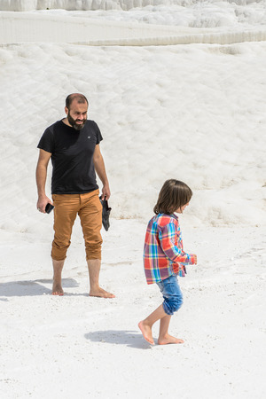 PAMUKKALE, TURKEY - APR 18, 2015: Unidentified tourists walk on the travertines of Pamukkale, Turkey. It's a UNESCO World Heritage siteのeditorial素材