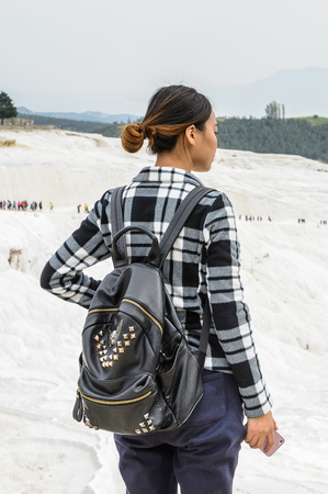 PAMUKKALE, TURKEY - APR 18, 2015: Unidentified beautiful girl on the travertines of Pamukkale, Turkey. It's a UNESCO World Heritage siteのeditorial素材