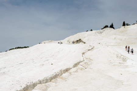 PAMUKKALE, TURKEY - APR 18, 2015: Unidentified tourists walk on the travertines of Pamukkale, Turkey. It's a UNESCO World Heritage siteのeditorial素材