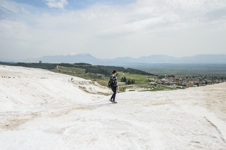 PAMUKKALE, TURKEY - APR 18, 2015: Unidentified beautiful girl on the travertines of Pamukkale, Turkey. It's a UNESCO World Heritage siteのeditorial素材