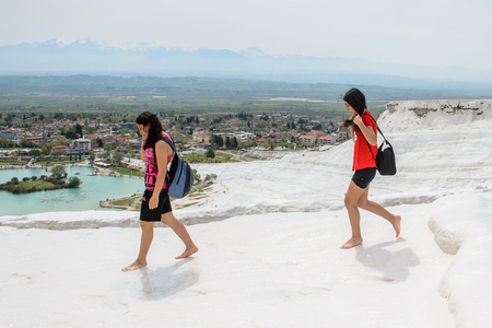 PAMUKKALE, TURKEY - APR 18, 2015: Unidentified girls walk over the travertines of Pamukkale, Turkey. It's a UNESCO World Heritage siteのeditorial素材