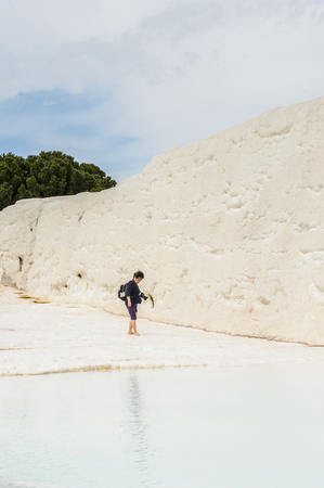 PAMUKKALE, TURKEY - APR 18, 2015: Unidentified tourist walks on the travertines of Pamukkale, Turkey. It's a UNESCO World Heritage siteのeditorial素材