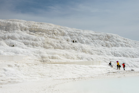 PAMUKKALE, TURKEY - APR 18, 2015: Unidentified tourists walk on the travertines of Pamukkale, Turkey. It's a UNESCO World Heritage siteのeditorial素材