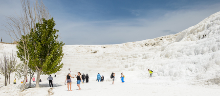 PAMUKKALE, TURKEY - APR 18, 2015: Unidentified tourists walk on the travertines of Pamukkale, Turkey. It's a UNESCO World Heritage siteのeditorial素材