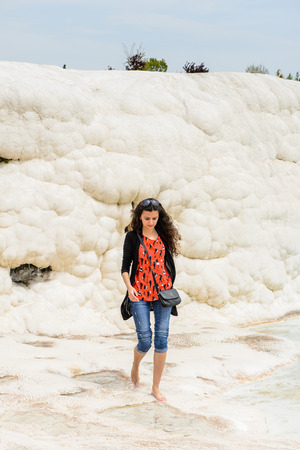 PAMUKKALE, TURKEY - APR 18, 2015: Unidentified beautiful girl on the travertines of Pamukkale, Turkey. It's a UNESCO World Heritage siteのeditorial素材