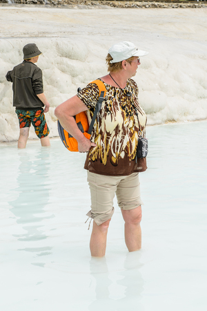 PAMUKKALE, TURKEY - APR 18, 2015: Unidentified tourist woman on the travertines of Pamukkale, Turkey. It's a UNESCO World Heritage siteのeditorial素材