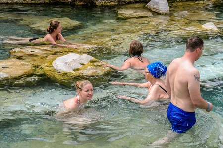 PAMUKKALE, TURKEY - APR 18, 2015: Unidentified tourists swim in the Antique pool (Cleopatra's Bath) in Pamukkale. It's a popular touristic destination during a Pamukkale visitのeditorial素材