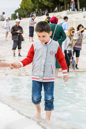 PAMUKKALE, TURKEY - APR 18, 2015: Unidentified little boy on the travertines of Pamukkale, Turkey. It's a UNESCO World Heritage siteのeditorial素材