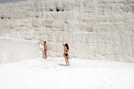 PAMUKKALE, TURKEY - APR 18, 2015: Unidentified beautiful girl in a swimming suit on the travertines of Pamukkale, Turkey. It's a UNESCO World Heritage siteのeditorial素材