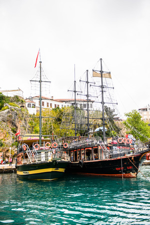 ANTALYA, TURKEY - APR 19, 2015: Touristic decorated ship in the Old harbour in Antalya (Kaleici), Turkey. Old town of Antalya is a popular destination among  touristsのeditorial素材