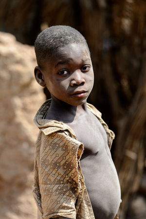 KARA REG., TOGO - JAN 14, 2017: Unidentified Konkomba little boy looks ahead in the village. Konkombas are ethnic group of Togoのeditorial素材