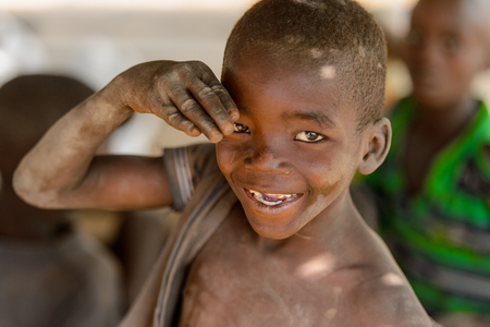 GHANI, GHANA - JAN 14, 2017: Unidentified Ghanaian soiled little boy smiles in the Ghani village. Ghana children suffer of poverty due to the bad economy.のeditorial素材