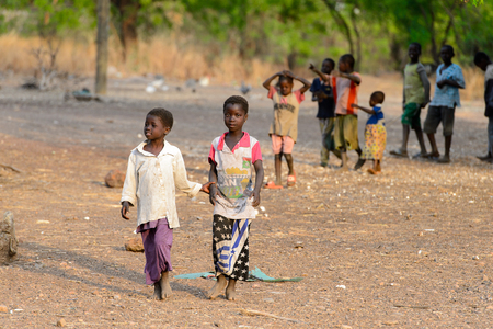 DAGOMBA VILLAGE, GHANA - JAN 14, 2017: Unidentified Dagomban children walk in the local village. Dagombas are ethnic group of Northern Ghanaのeditorial素材