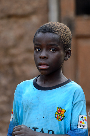 DAGOMBA VILLAGE, GHANA - JAN 14, 2017: Unidentified Dagomban boy in blue shirt looks away in the local village. Dagombas are ethnic group of Northern Ghanaのeditorial素材